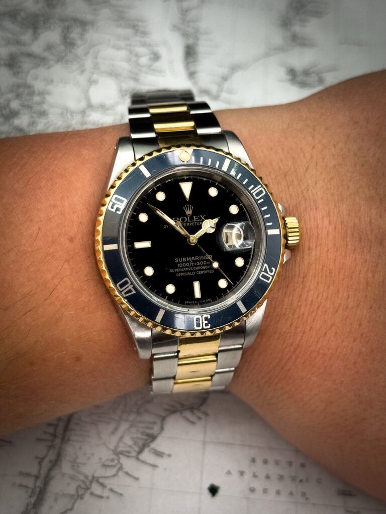 Two tone Rolex submariner on a mans wrist purchased by trusted watch buyer in Denver, Colorado